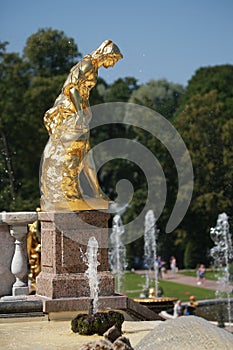 Gilded female statue. The sculptural ensemble of the Grand Cascade on a sunny day, close-up. Peterhof