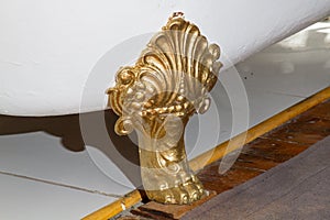 Gilded foot of antique enameled bath tub