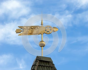 Gilded gold weather vane atop the Grapevine Convention and Visitors Bureau in the historic district of Grapevine, Texas.