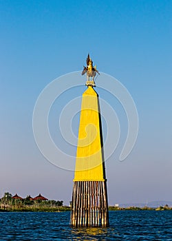 Gilded Hintha bird obelisk in the middle of Inle Lake, Myanmar.