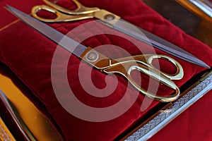 Gilded scissors on red cushion for cutting the ribbon for the opening ceremony