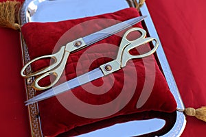 Gilded scissors on red cushion for cutting the ribbon for the opening ceremony