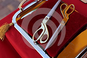 Gilded scissors on red cushion for cutting the ribbon for the opening ceremony