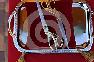 Gilded scissors on red cushion for cutting the ribbon for the opening ceremony