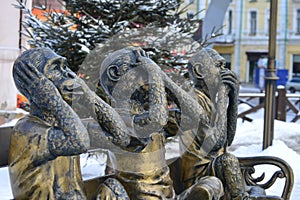 Gilded sculpture of three monkeys . I do not say , I do not see , can not hear