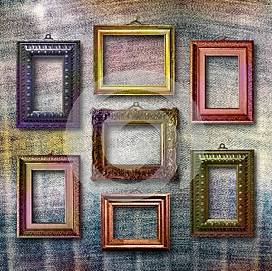 Gilded wooden frames for pictures on jeans background