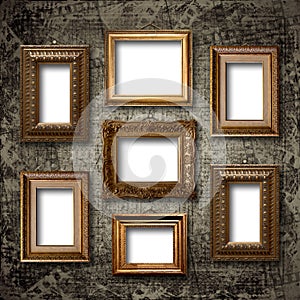 Gilded wooden frames for pictures on stone wall