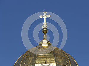 Gilding the dome of the Orthodox cathedral against the blue sky photo