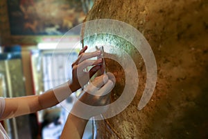 Gilding a gold leaf on the back of buddha stature photo