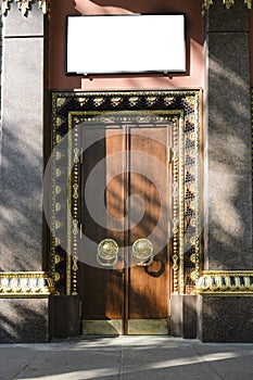 Gilding and monumental tree. entrance, gates, doors to a Buddhist temple. the concept of reliable protection