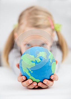 Gilrl holding the earth globe