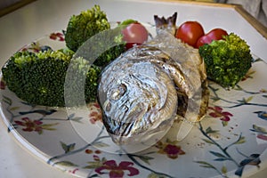 Gilt-head bream fish grilled with tomato and broccoli