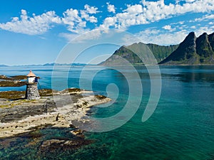 Gimsoy lighthouse on sea rocks, Lofoten Norway