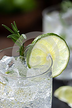 Gin and tonic cocktail with lime and rosemary