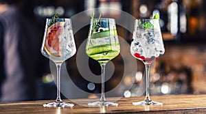 Gin tonic cocktails in wine glasses on bar counter in pup or restaurant