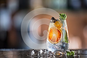 Gin tonic cocktailwith fresh tropical fruit on bar counter in pup or restaurant photo