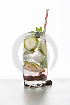 Gin tonic with lime, ice and red fruit