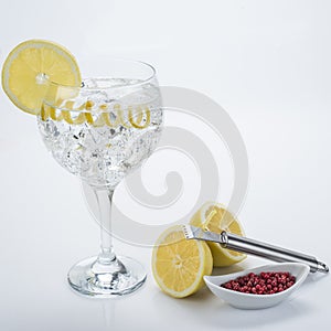 Gin and tonic with pink pepper and lemon twist