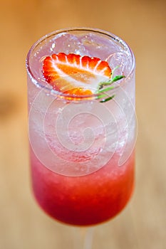 Gin Tonic with strawberry syrup and lemon slice photo