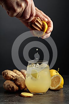 Ginger Ale with ice and lemon on a black background