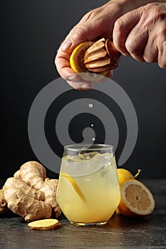 Ginger Ale with ice and lemon on a black background