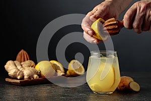 Ginger Ale with ice and lemon on a black background