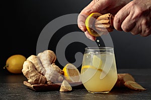 Ginger Ale with ice and lemon on a black background