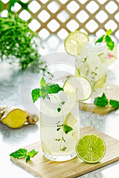 Ginger Ale or Kombucha in glass Homemade cocktail lime and ginger limonade. Indian drink to refresh