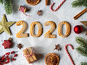 Ginger biscuits of the form of a numbers and 2020 new year ginger cookies on grey background. Top view. Seasonal packaging and New