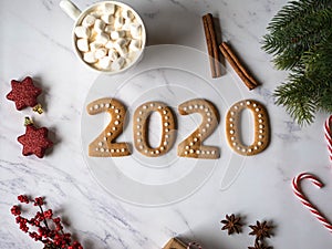 Ginger biscuits or gingerbread of form of numbers and 2020 new year ginger cookies white marble background. Top view. New Year`s