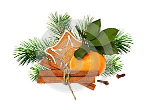 Ginger cookie, tangerine, cinnamone, cloves and green pine twigs in a Christmas arrangement photo
