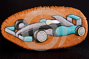Ginger and delicious gingerbread in the form of a formula one car on a glossy board