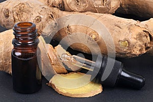 Ginger essential oil close-up on black background