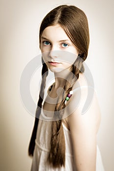 Ginger girl with blue eyes and plaits