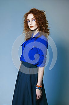 Ginger girl with color make-up and curly hairdo
