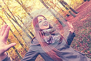 Ginger girl playing in forest.