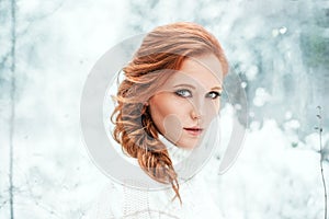 Ginger happy female in white sweater in winter forest. Snow december in park. Portrait. Christmas cute time.