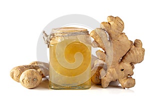 Ginger jam and fresh ginger isolated on a white background
