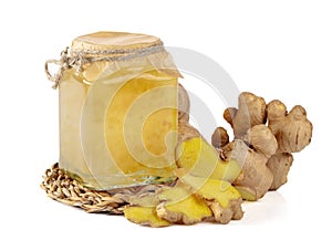 Ginger jam and fresh ginger isolated on a white background