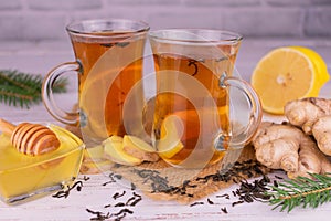 Ginger-lemon tea with honey in transparent cups.