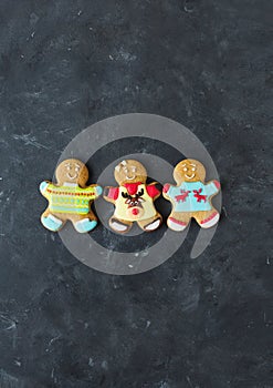 Ginger men with colored glaze on a gray background .. Gingerbread. Christmas cookies.