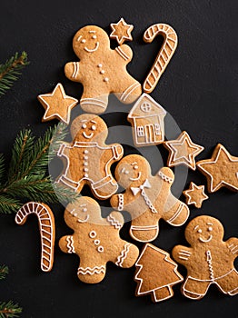 Ginger men with glaze on a black background . Gingerbread. Christmas cookies