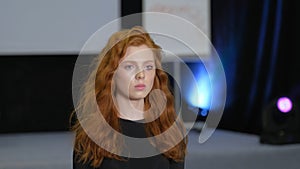 Ginger model walking on defile podium. Catwalk runway by redhead girl lace dress photo