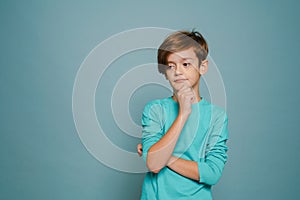 Ginger puzzled boy wearing long sleeve posing and looking aside