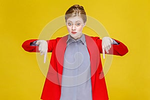 Ginger red head woman in red suit wish pointing down at copy spa