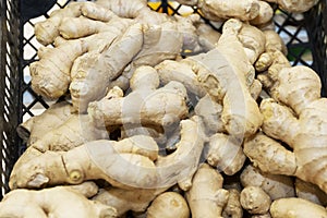 Ginger root in a basket on the counter in the store. Prevention of colds