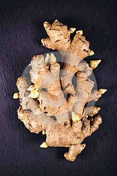 Ginger root on a black stone background