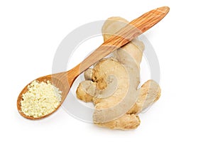 Ginger root and ginger powder in wooden spoon