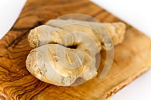 Ginger root, isolated on the wooden background