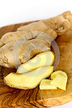 Ginger root, isolated on the wooden background